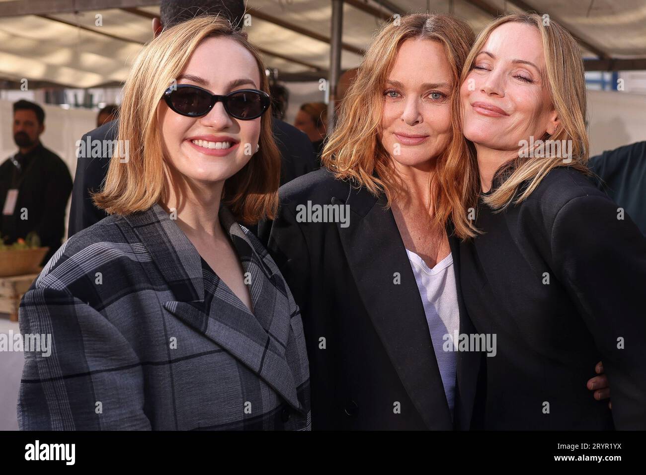Maude Apatow, left, and Leslie Mann, right, pose with Stella McCartney
