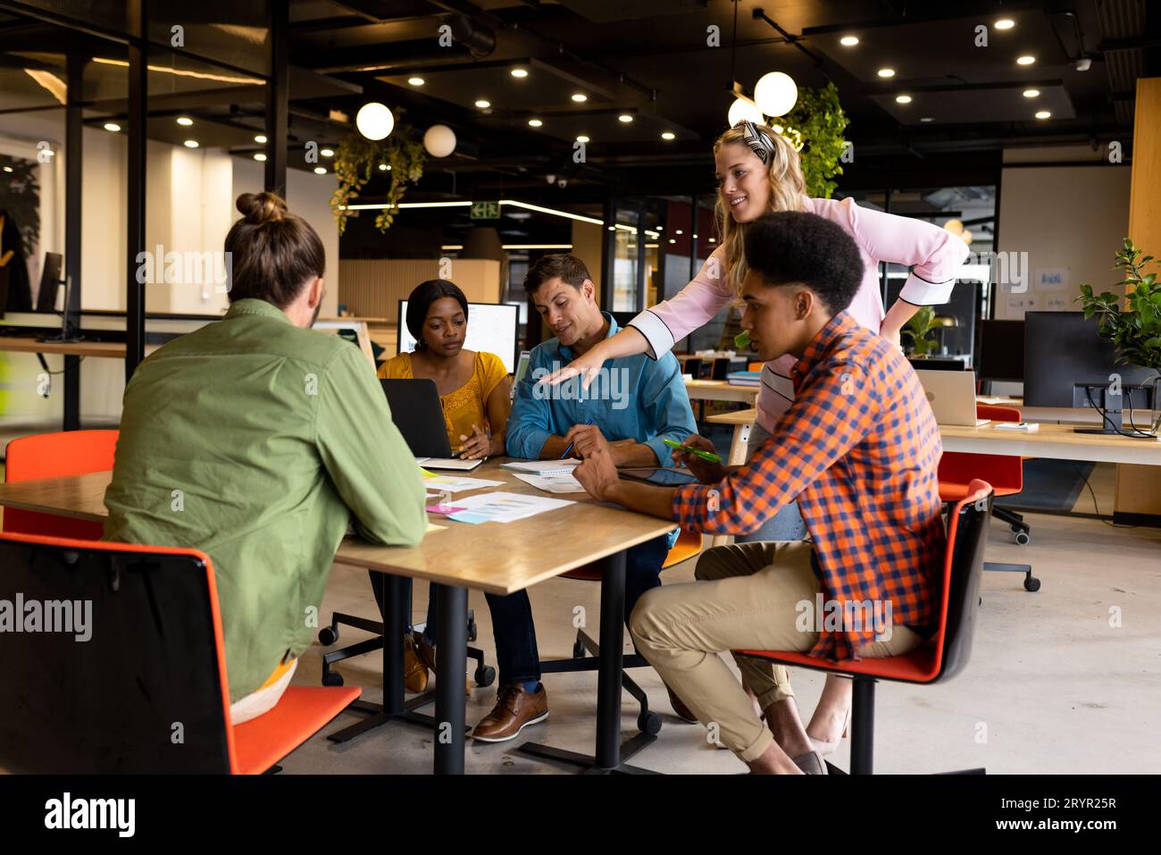 Diverse creative colleagues in discussion brainstorming using notes, tablet and laptop Stock Photo