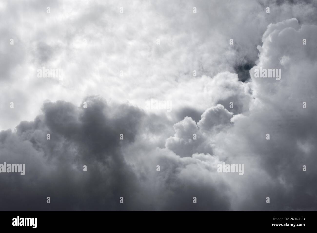 A small clearing reveals the blue sky between dark storm clouds in Lugo Galicia Stock Photo