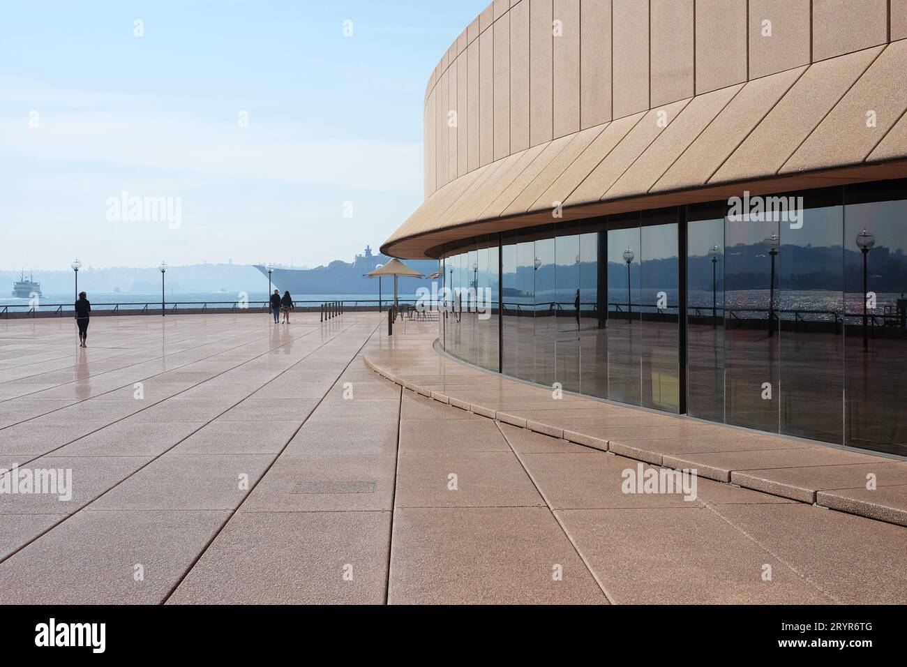 Reflected in the glass wall of the Sydney Opera House on the Northern Boardwalk a wide panorama of Cremorne, Sydney Harbour, Rose Bay and Vaucluse Stock Photo