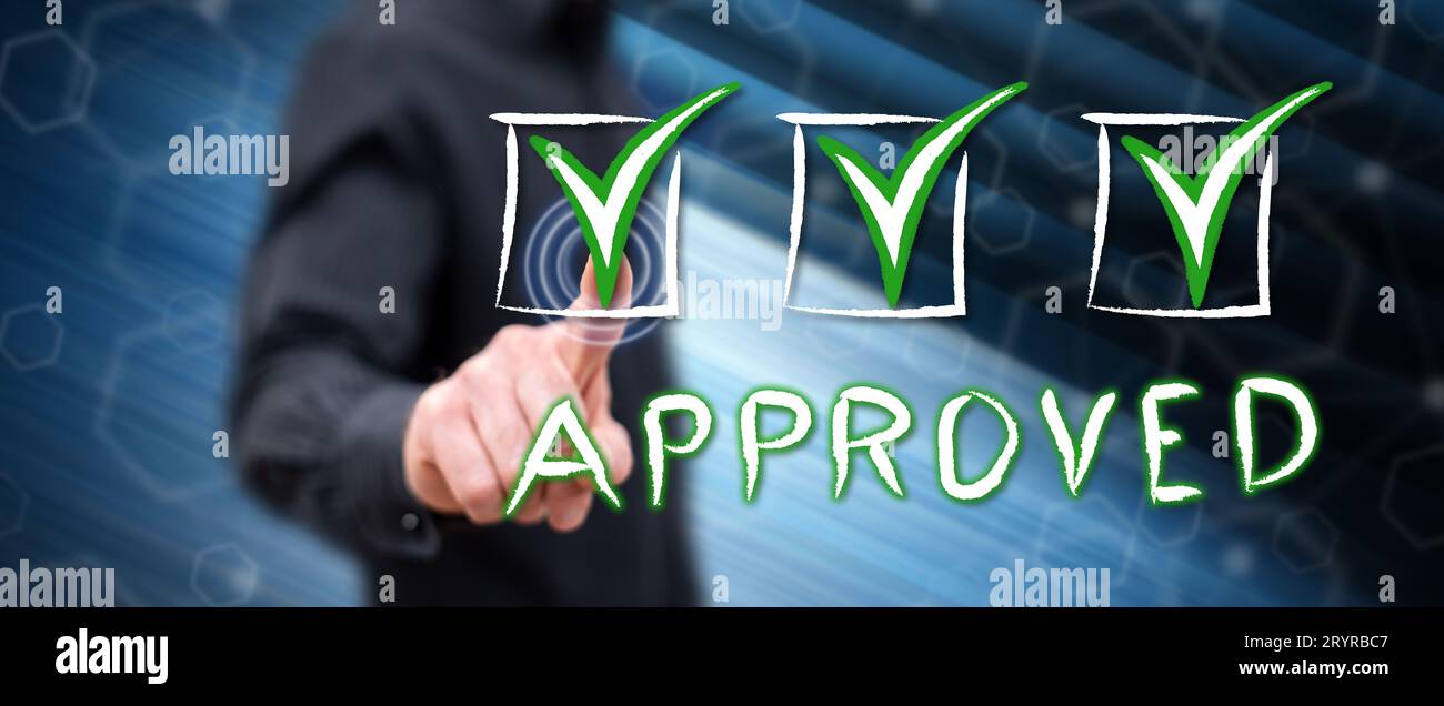 Man touching a validation concept on a touch screen with his finger Stock Photo