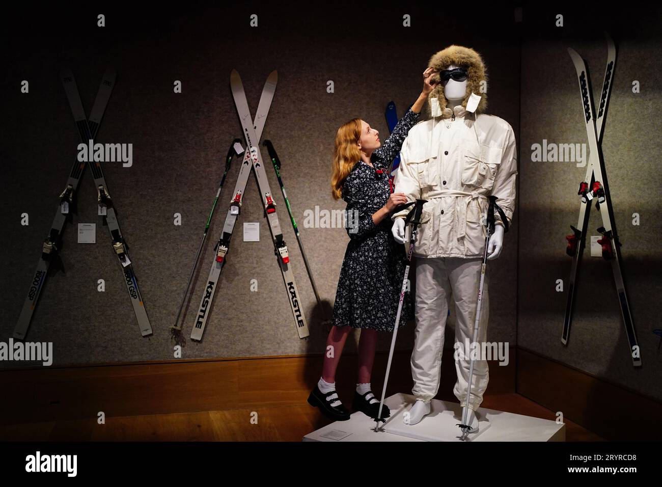 A gallery assistant adjusts a Bogner white ski suit purchased for Roger Moore in 'A View to a Kill' in 1985, valued at £15,000 -£25,000, which is on show at Bonhams, London, ahead of the Sir Roger Moore: The Personal Collection sale at the auction house. Picture date: Monday October 2, 2023. Stock Photo