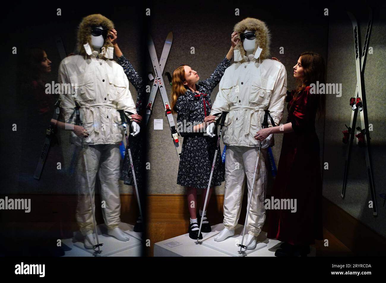 Gallery assistants adjust a Bogner white ski suit purchased for Roger Moore in 'A View to a Kill' in 1985, valued at £15,000 -£25,000, which is on show at Bonhams, London, ahead of the Sir Roger Moore: The Personal Collection sale at the auction house. Picture date: Monday October 2, 2023. Stock Photo