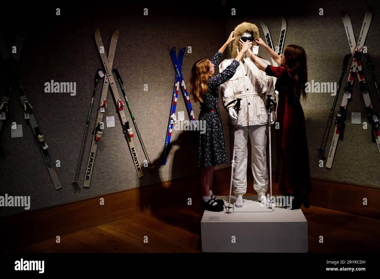 Gallery assistants adjust a Bogner white ski suit purchased for Roger Moore in 'A View to a Kill' in 1985, valued at £15,000 -£25,000, which is on show at Bonhams, London, ahead of the Sir Roger Moore: The Personal Collection sale at the auction house. Picture date: Monday October 2, 2023. Stock Photo