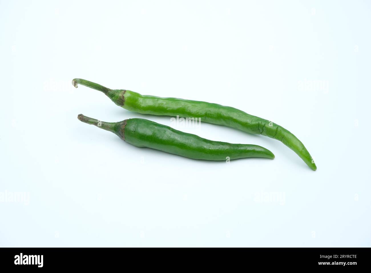 Green Chili peppers are isolated in white background Stock Photo - Alamy