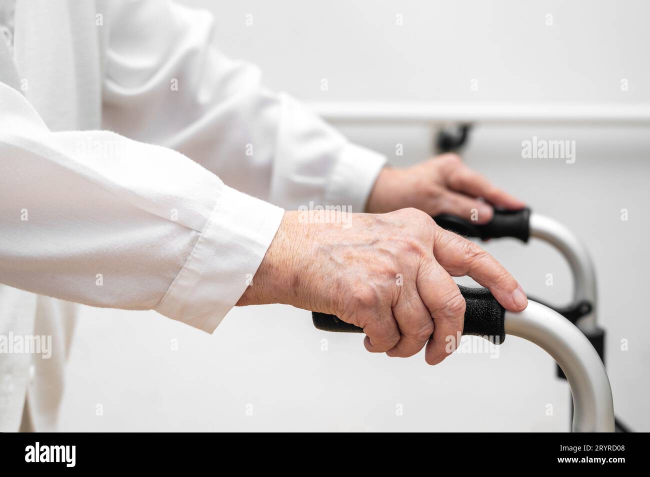 Senior patient on folding walker. Recuperation for elderly, seniors care, nursing home. Stock Photo