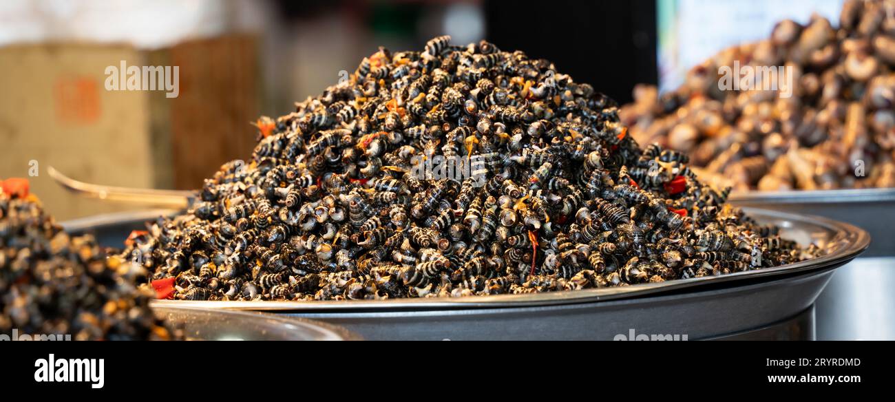 Stir-fried spicy flavored snail meat, delicious traditional street food in Taiwan. Stock Photo