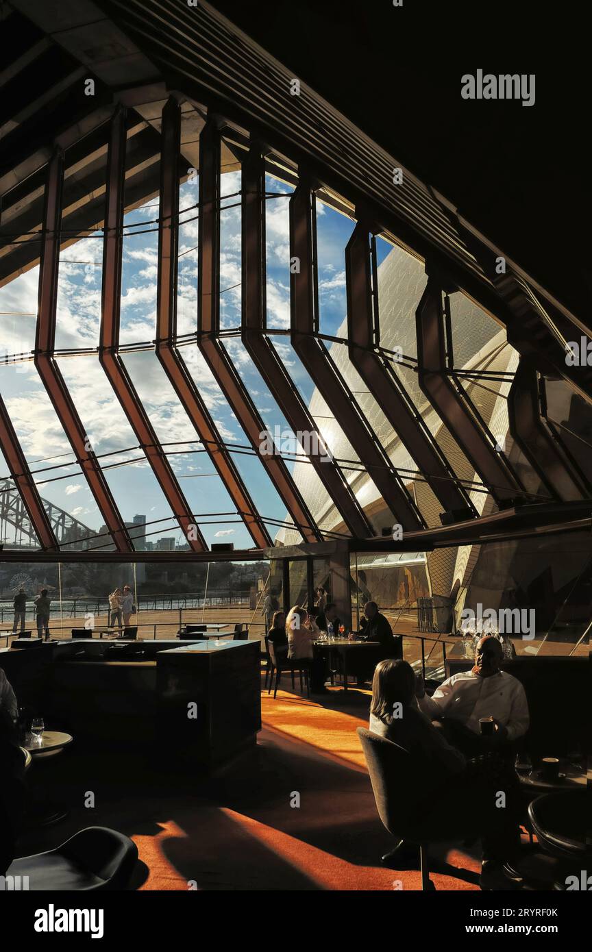 Interior view of the bar area at Bennelong Restaurant at Sydney Opera House, Concert Hall Sails and Sydney Harbour Bridge on a sunny day Stock Photo