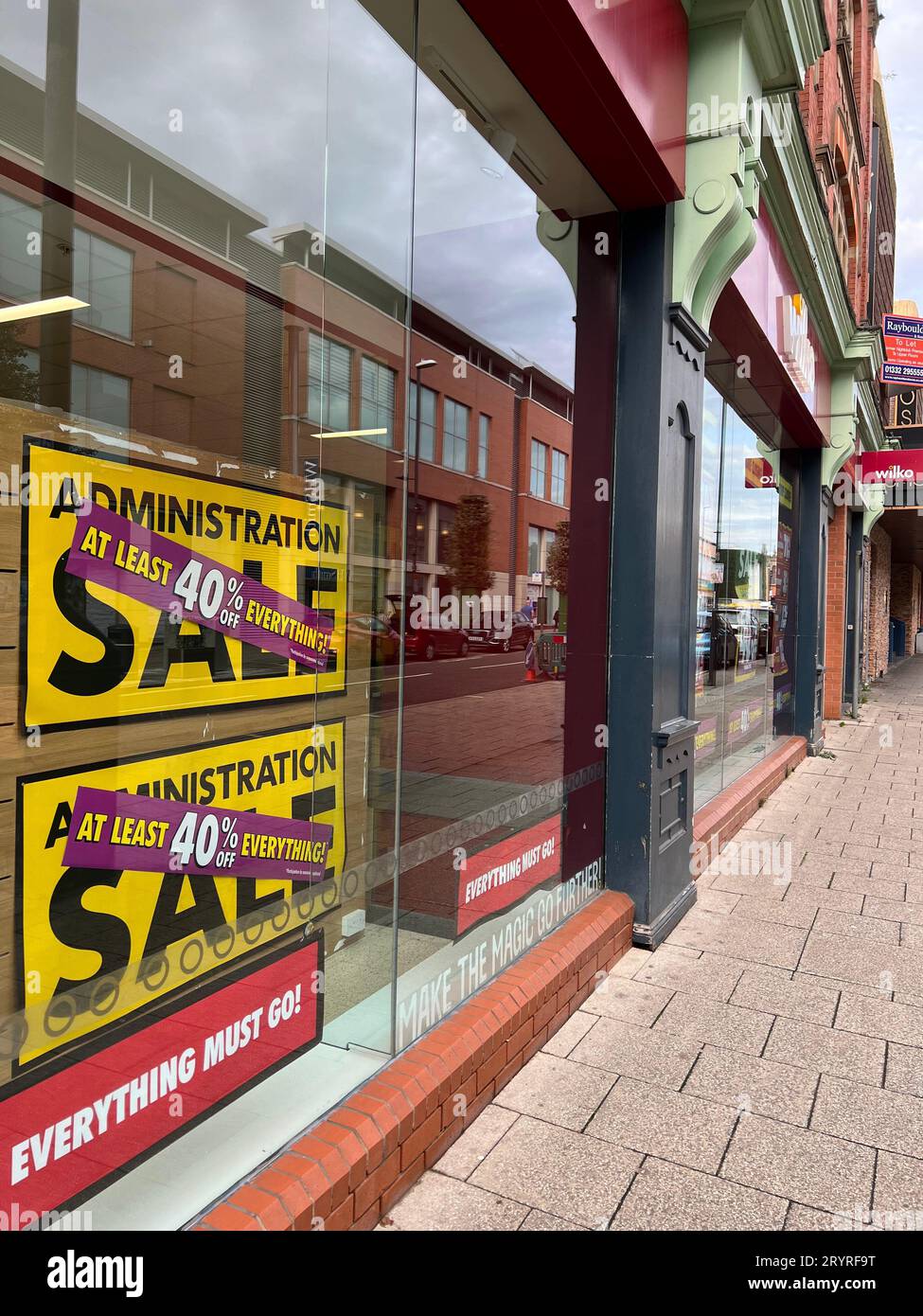 A sign in the window of Wilko retail store reading 'Administration sale and ‘“everything must go” during the final week of trading at the Derby store in England, U.K. Popular U.K retailer 'Wilko' (formerly Wilkinson Hardware Stores) announced on August 10th 2023 that it was entering into administration. Putting 12,500 jobs at risk. The company has 400 shops across the U.K.  Ben Booth/Alamy Stock Photo