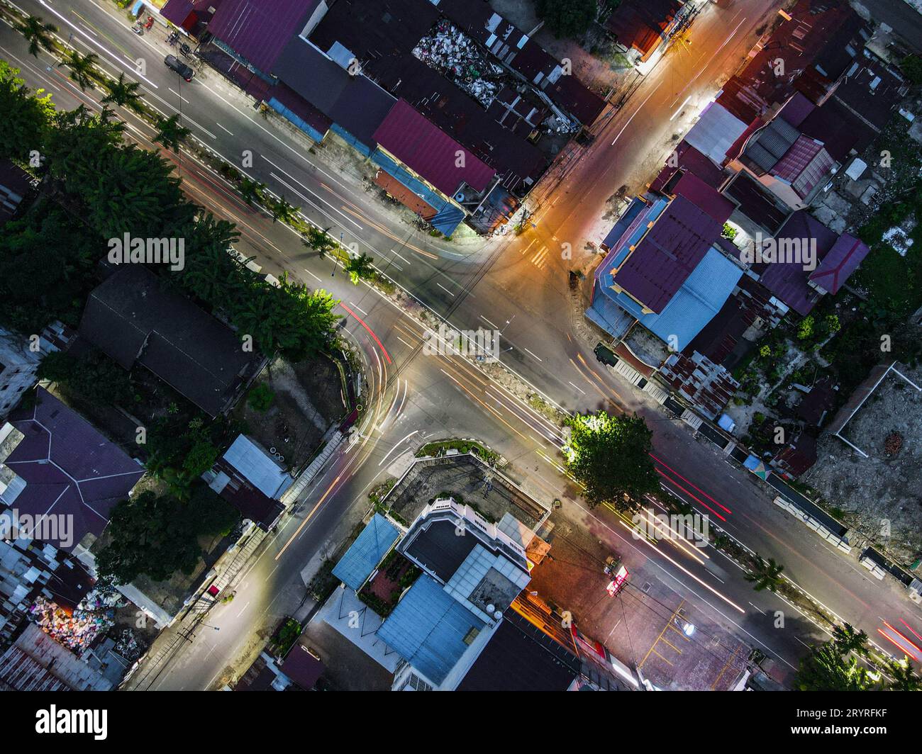 An aerial view of a busy intersection in a city at nighttime. Stock Photo
