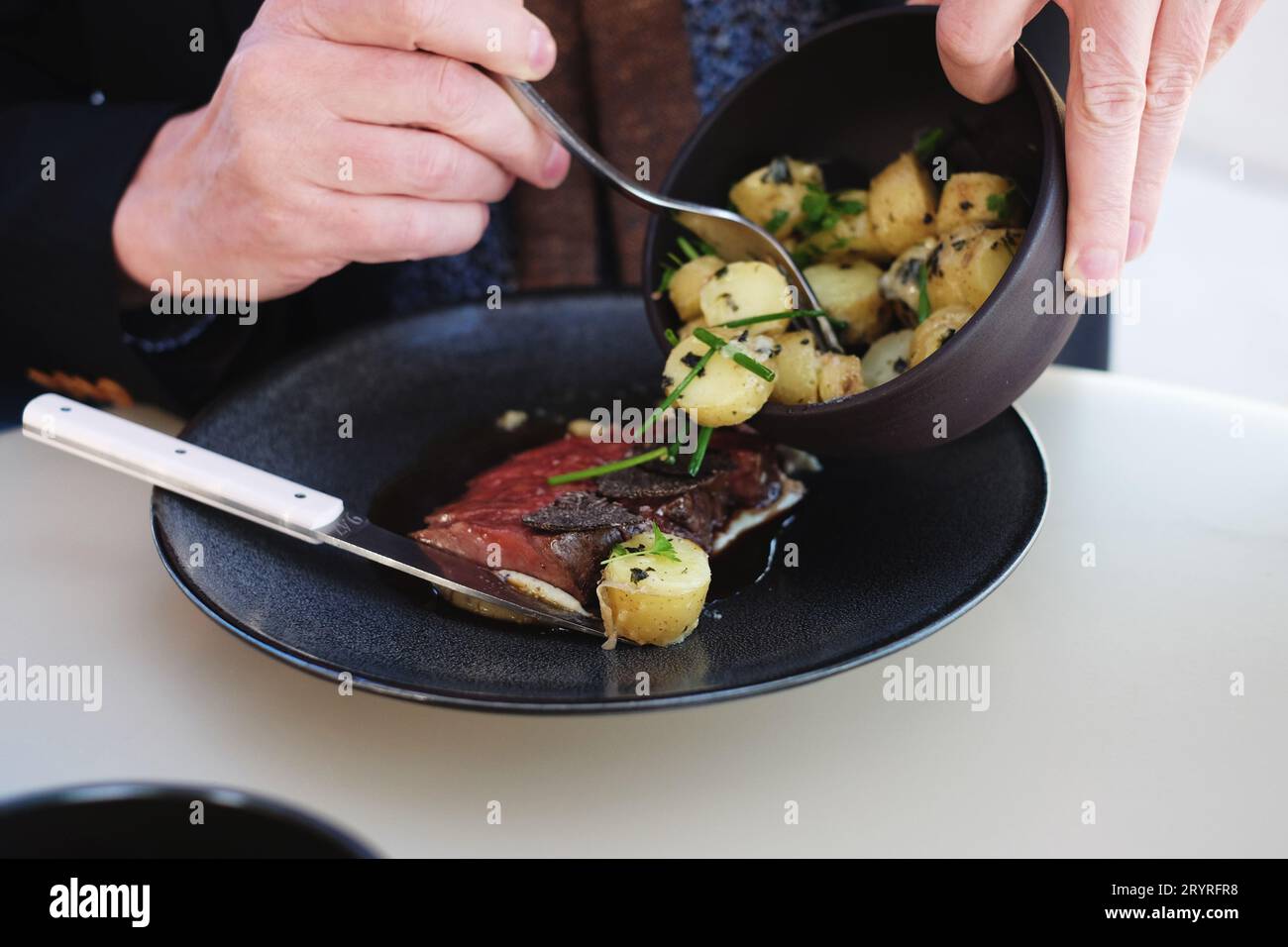 Adding potatoes to the Blackmore Wagyu (9+) with WA Truffle, Madeira
