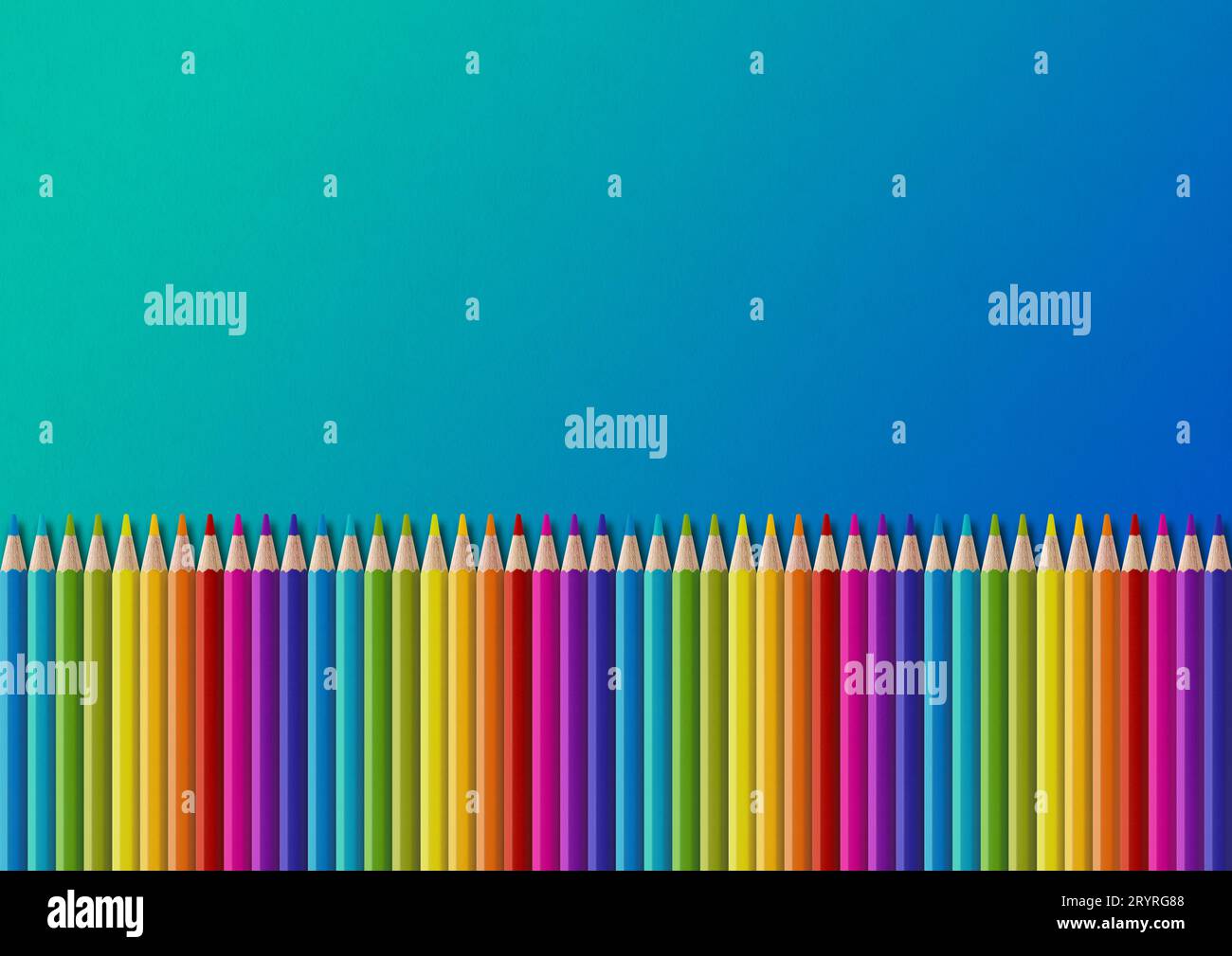 Colored pencil group isolated on blue. Horizontal background Stock Photo