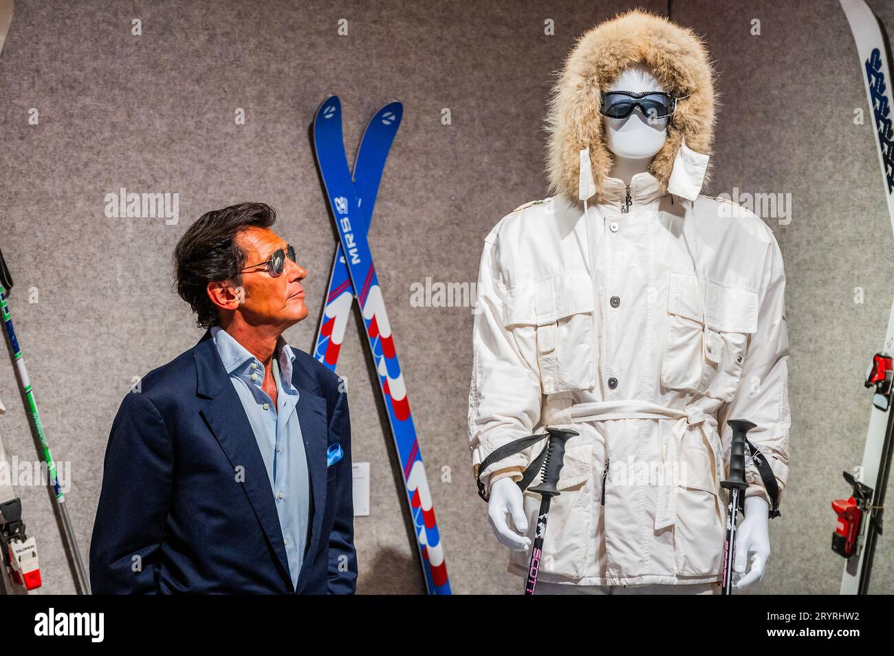 London, UK. 2nd Oct, 2023. Geoffrey Moore (his son) with A Bogner white ski suit purchased for Sir Roger Moore in A View to a Kill, 1985, est £15,000 - £25,000 -  Roger Moore: The Personal Collection at Bonhams New Bond Street, London. On 4 October, 180 lots will be auctioned, marking the 50th anniversary year of his first appearance as 007. Credit: Guy Bell/Alamy Live News Stock Photo