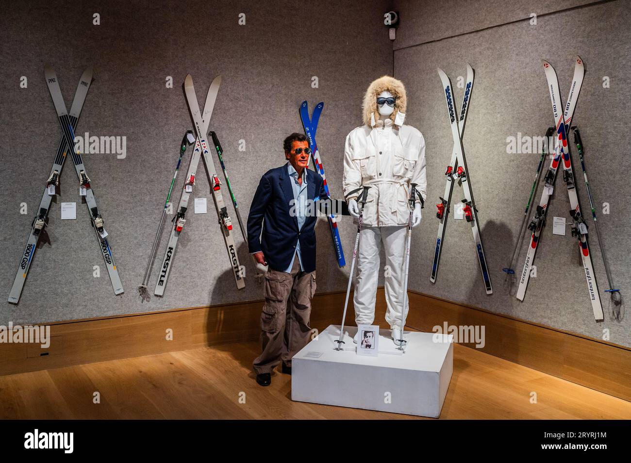 London, UK. 2nd Oct, 2023. Geoffrey Moore (his son) with A Bogner white ski suit purchased for Sir Roger Moore in A View to a Kill, 1985, est £15,000 - £25,000 -  Roger Moore: The Personal Collection at Bonhams New Bond Street, London. On 4 October, 180 lots will be auctioned, marking the 50th anniversary year of his first appearance as 007. Credit: Guy Bell/Alamy Live News Stock Photo