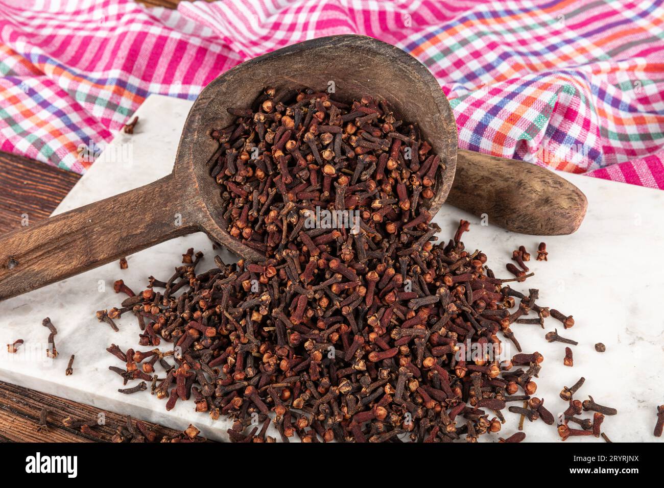 Dry spice cloves. Cloves spread on the ground on wooden background