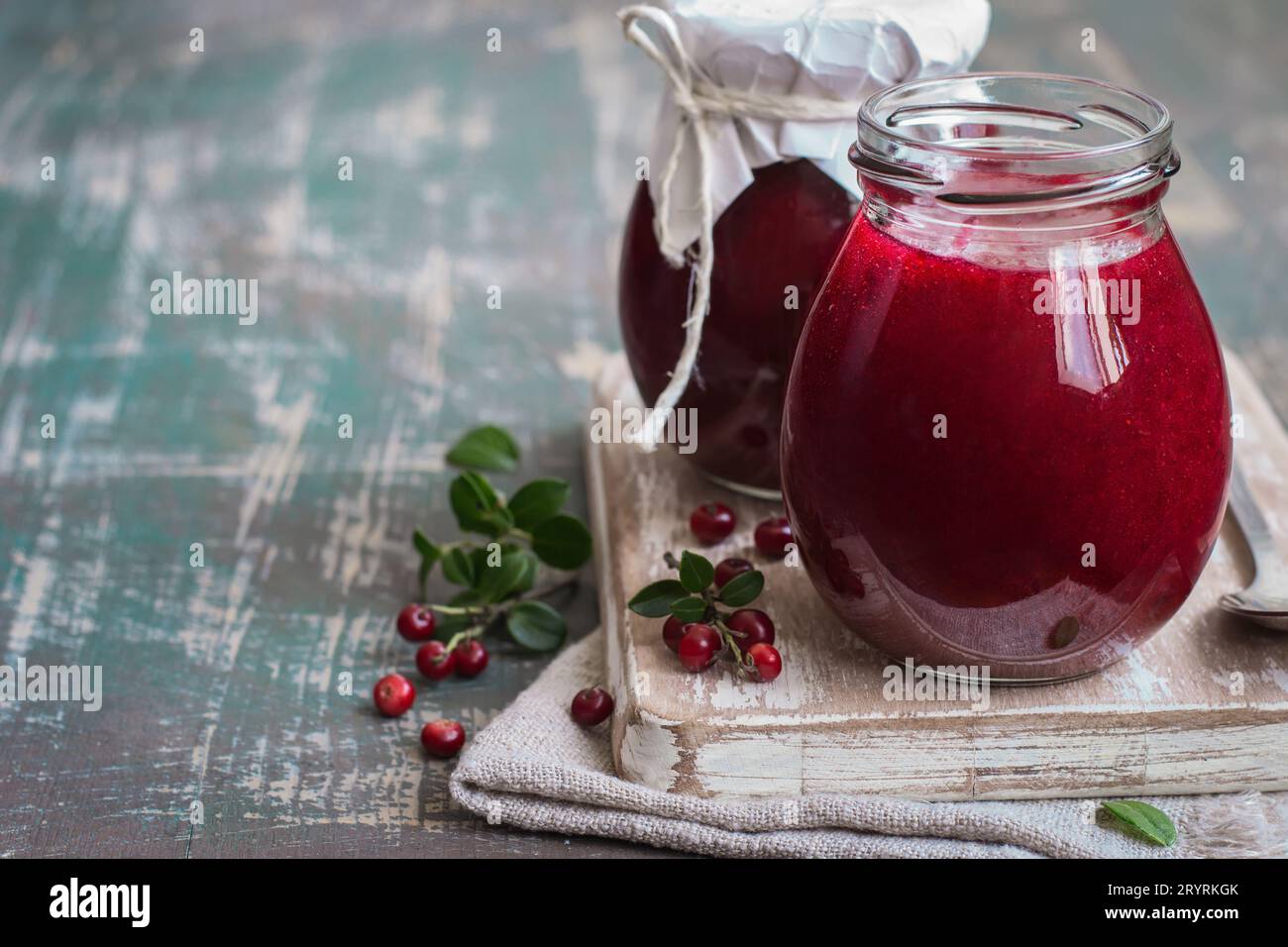 Lingonberry jam in jar and fresh berries. Selective focus, copy Stock Photo