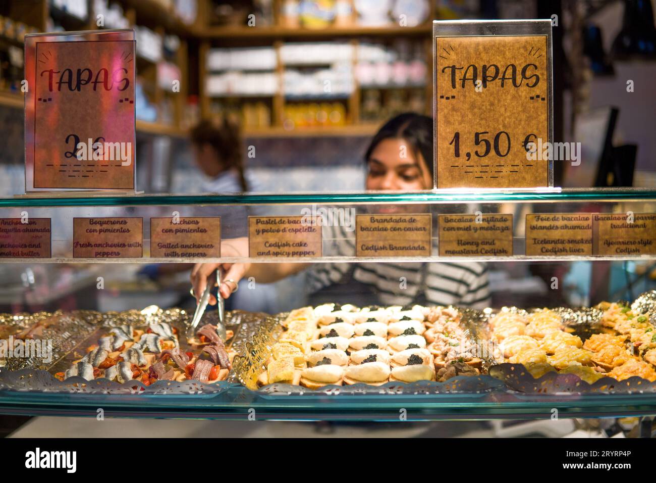 Waitress Serving a Spanish Tapa, Typical Appetizer, in the Window of a
