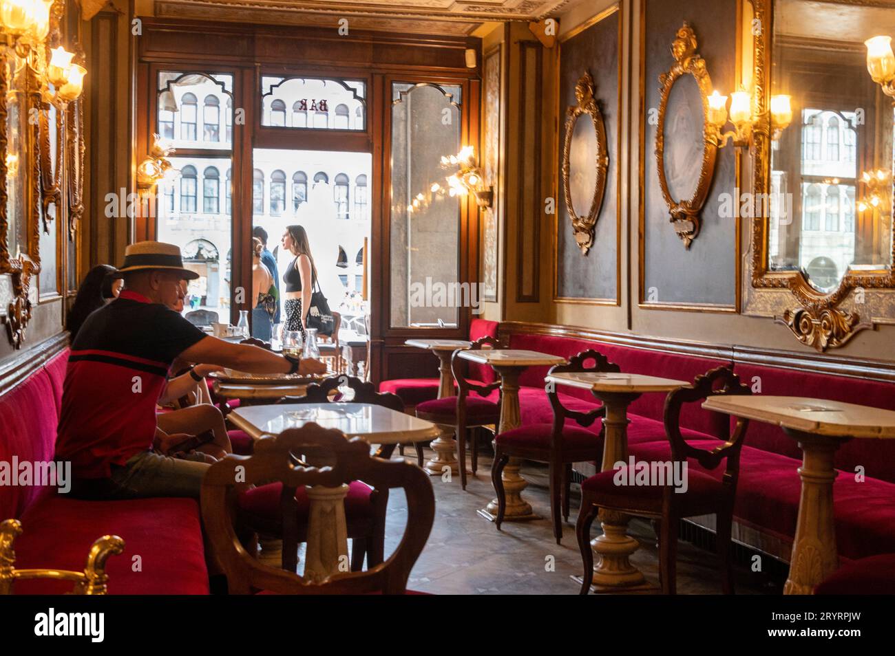 Seated customers at Caf Florian on Piazza San Marco, (St. Marks Square) in Venice in the Venetian region of northern Italy.  Florian was founded in 1 Stock Photo