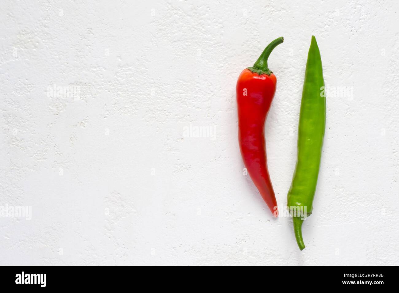 Red and green hot peppers on a white background Stock Photo - Alamy