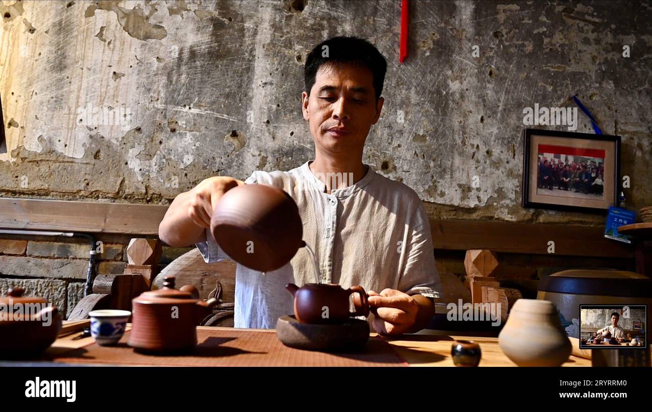 (231002) -- BEIJING, Oct. 2, 2023 (Xinhua) -- Zou Yingwen, an inheritor of Wuyi Mountains tea-making techniques, makes tea in Xiamei Village, Wuyishan City, southeast China's Fujian Province, Sept. 5, 2023. (Xinhua/Jiang Kehong) Stock Photo