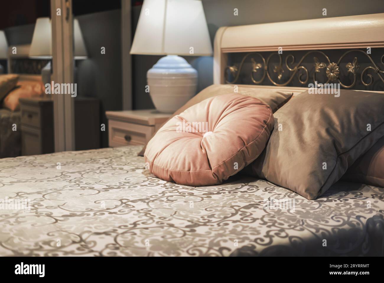 Classic style bed with velvet pillows on floral design bedspread ...