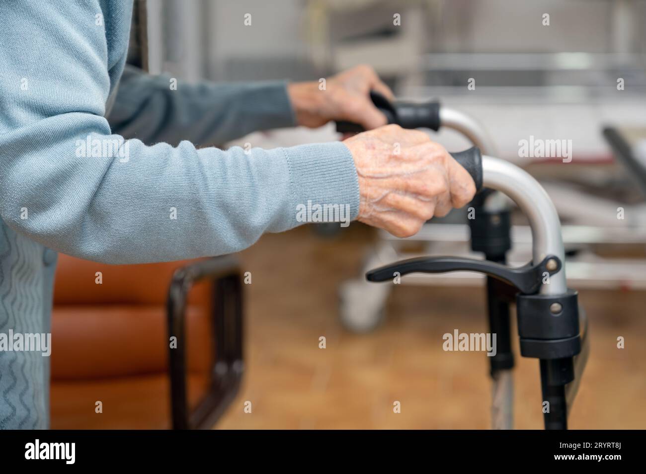 Senior patient on folding walker. Recuperation for elderly, seniors care, nursing home. Stock Photo