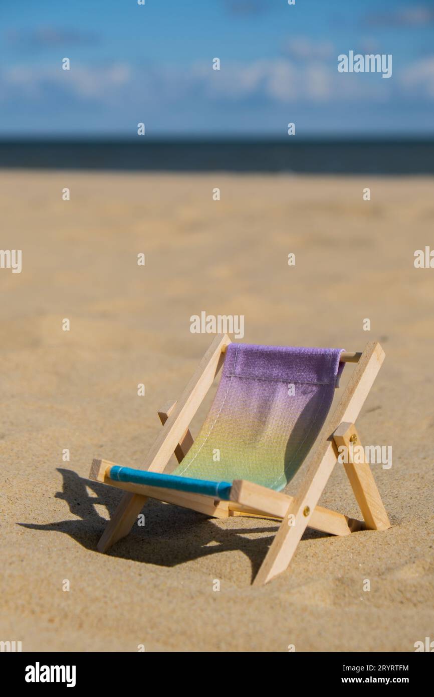 Sunny holidays on the beach sand beach accessories. Sun lounger stand sea. Wooden beach chairs. Summer holiday vacation concept. Stock Photo
