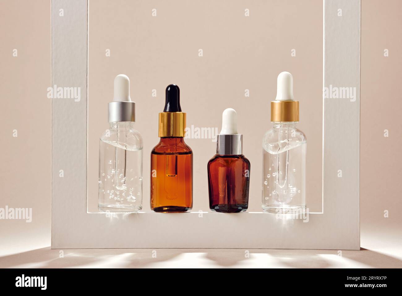 Anti-age cosmetic. Skincare collagen serum bottles. Neutral backgrounds and hard shadows Stock Photo
