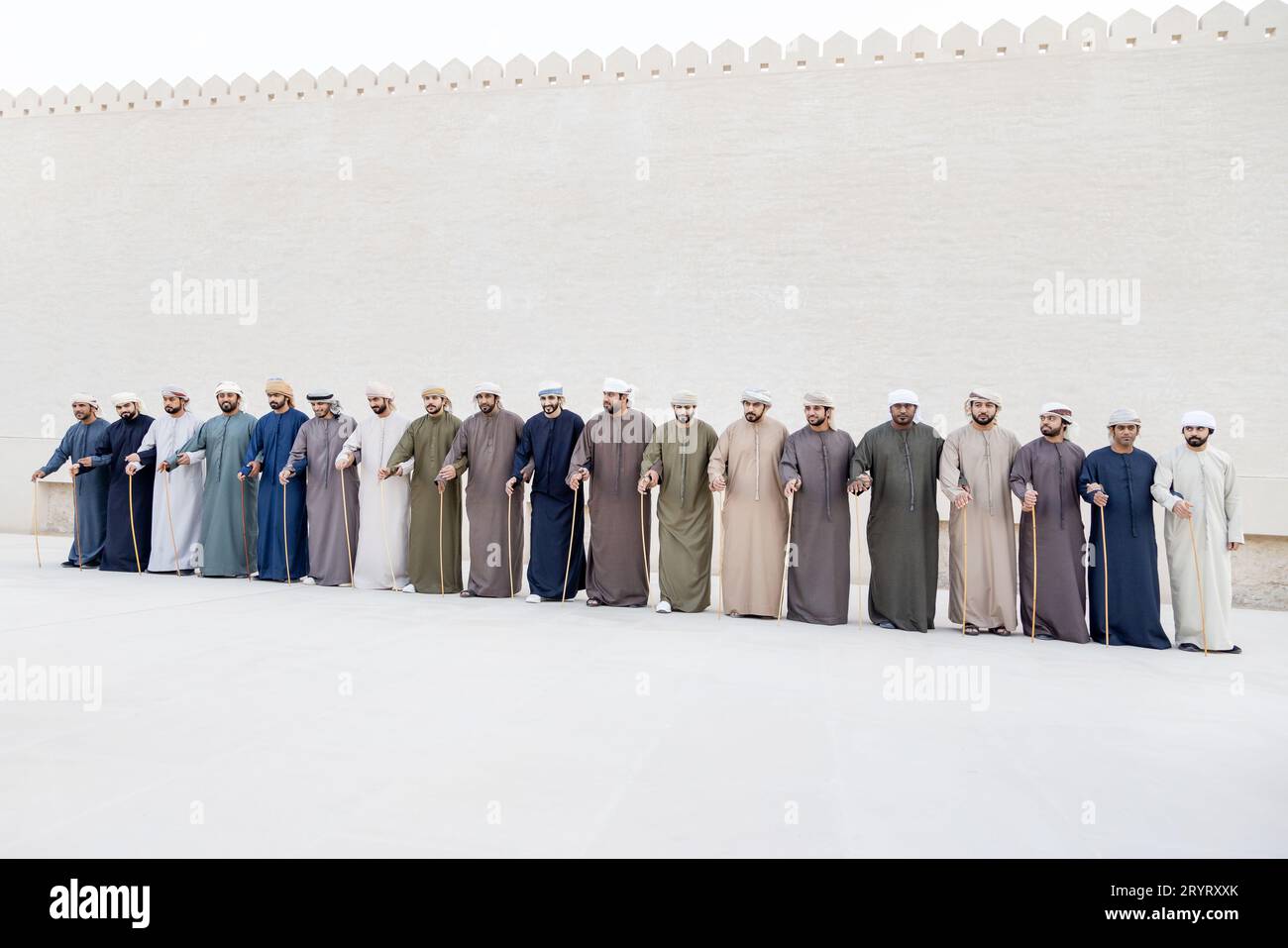 Abu Dhabi, UAE - January 21, 2023: Men in a line doing traditional Emirati Al Ayalah dance at Al Hosn Festival Stock Photo
