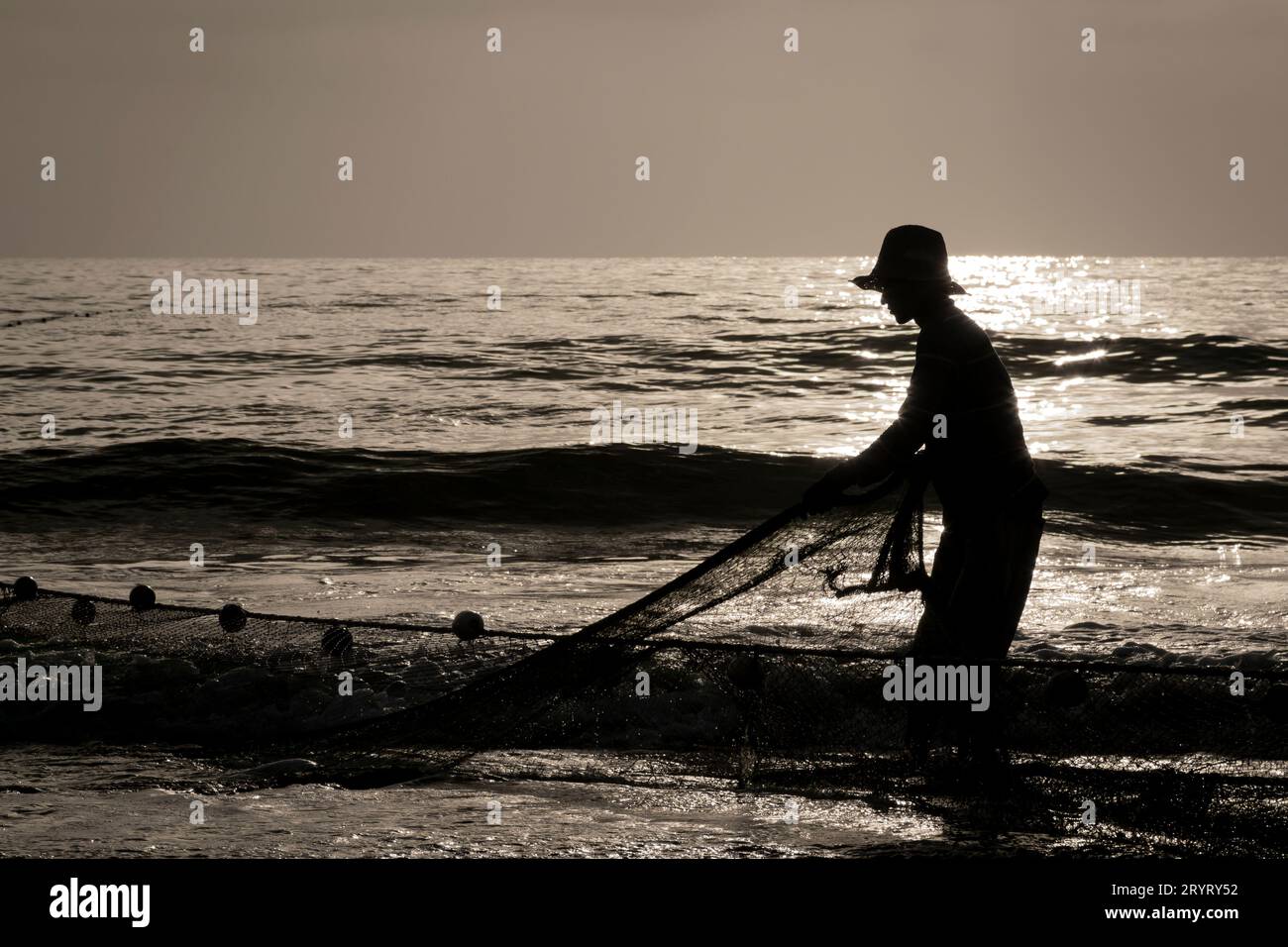 Fujairah, UAE - October 10, 2014: Fishermen with their catch on the beach at Fujairah in the United Arab Emirates. Stock Photo