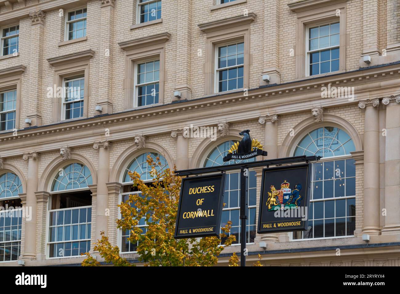 Hanging signs outside the Duchess Of Cornwall inn pub, Hall & Woodhouse pub,  in Queen Mother Square at Poundbury, Dorchester, Dorset UK in September Stock Photo