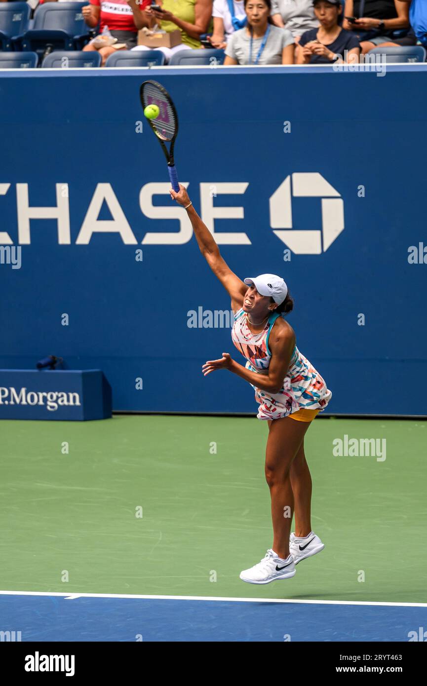 A female athlete in a tennis court, sporting a racquet and ball at US