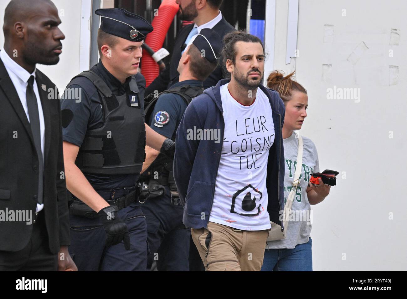 Paris, France. 02nd Oct, 2023. An activist from Derniere Renovation caught by security guards and policemen during Louis Vuitton SS 24 show during Paris Fashion Week on October 2, 2023 in Paris, France. Photo by Julien Reynaud/APS-Medias/ABACAPRESS.COM Credit: Abaca Press/Alamy Live News Stock Photo