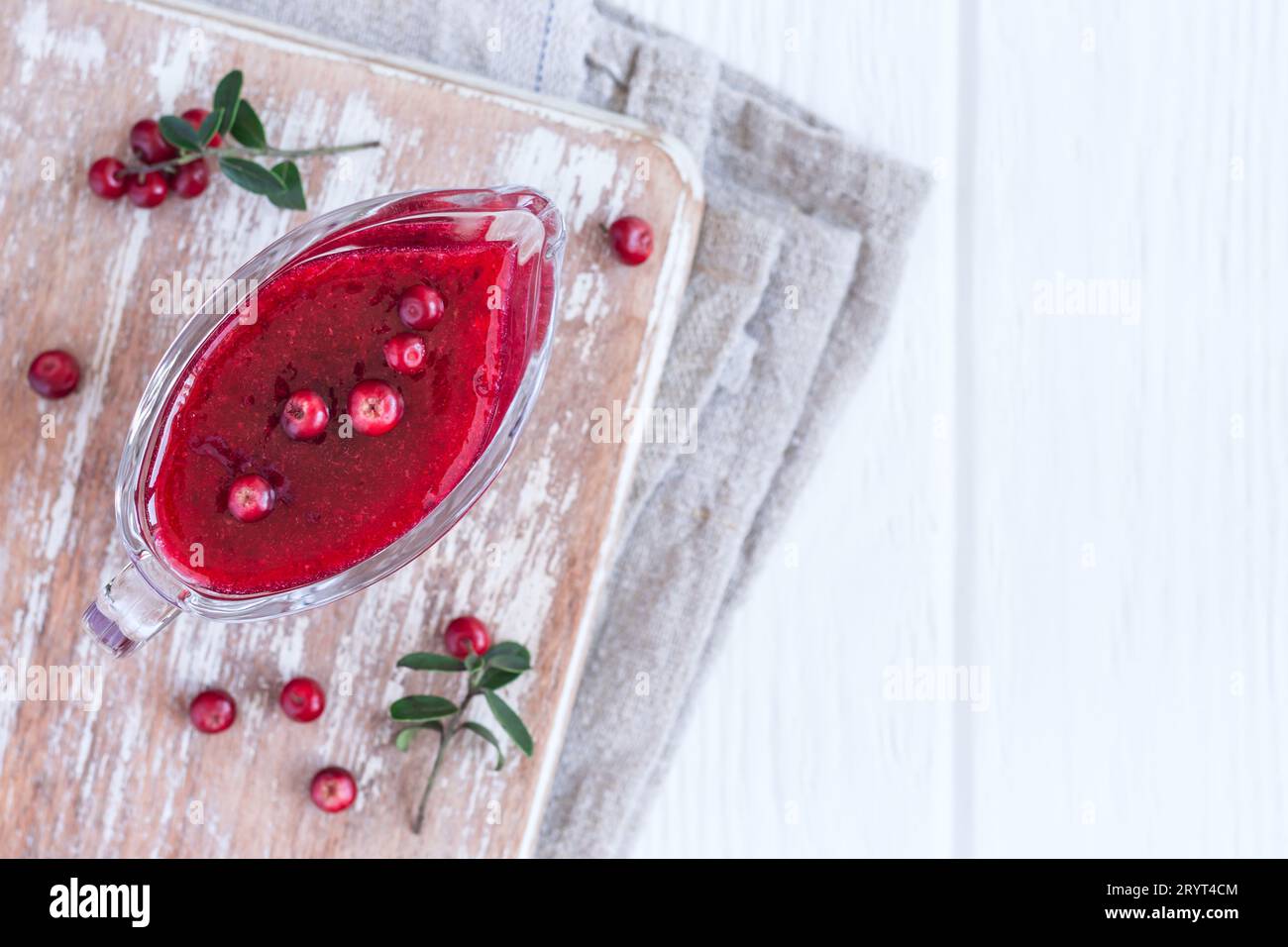 Fresh Lingonberry sauce in a gravy boat. Top view with copy space Stock Photo