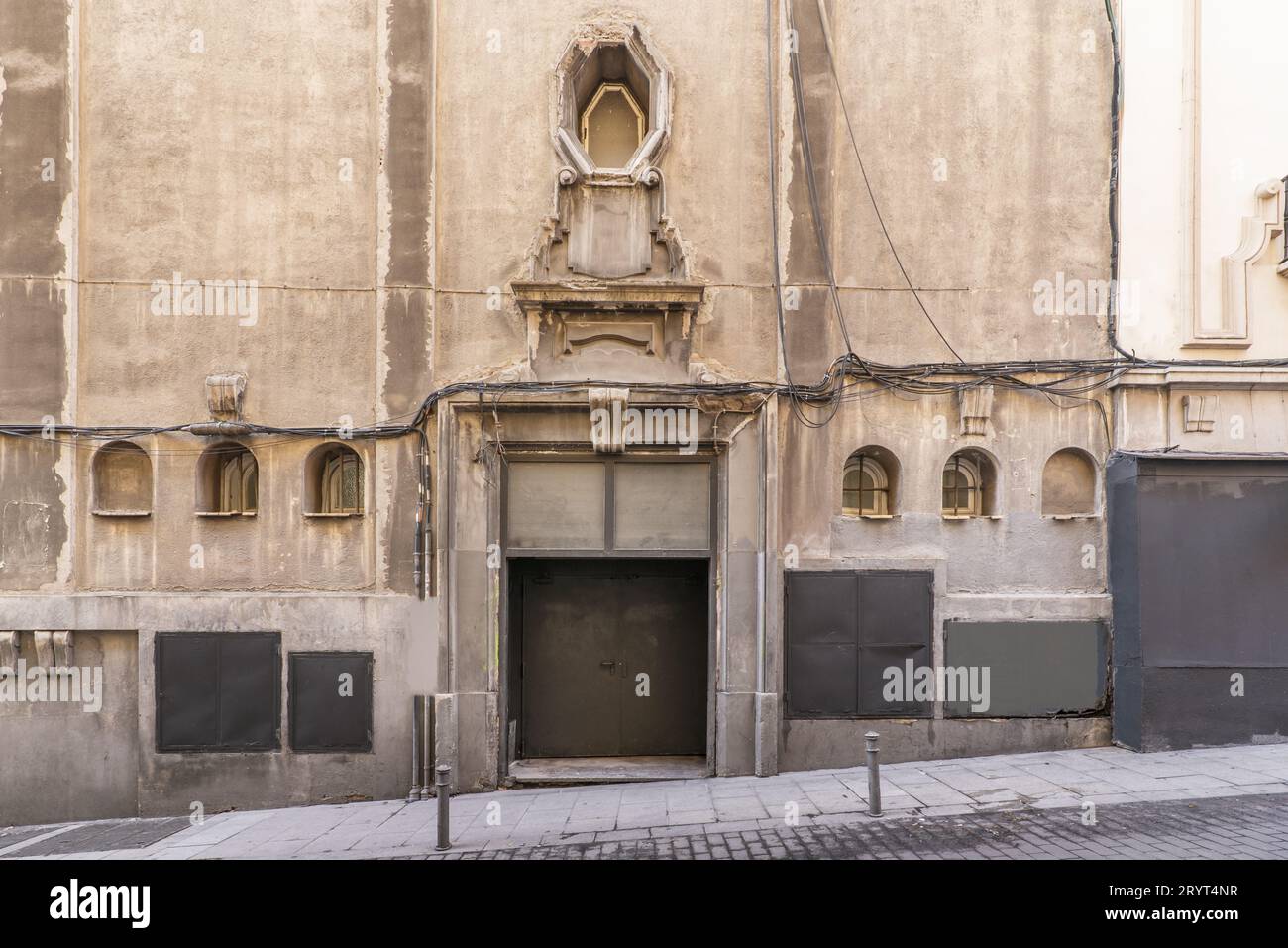 Facade of a very old building with granite ashlars, windows with old ...