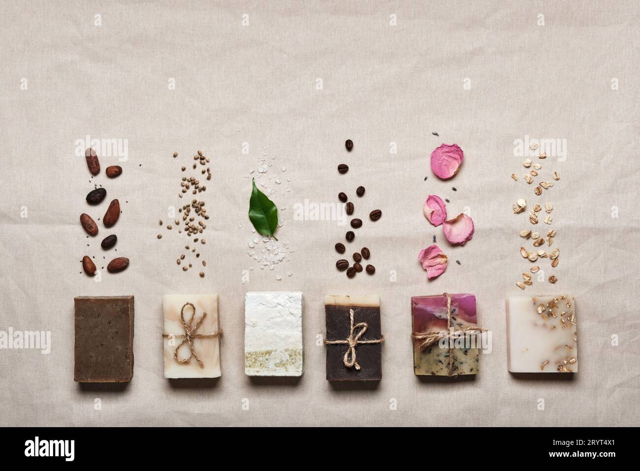 Natural soap bars with ingredients on linen cloth background. Diy