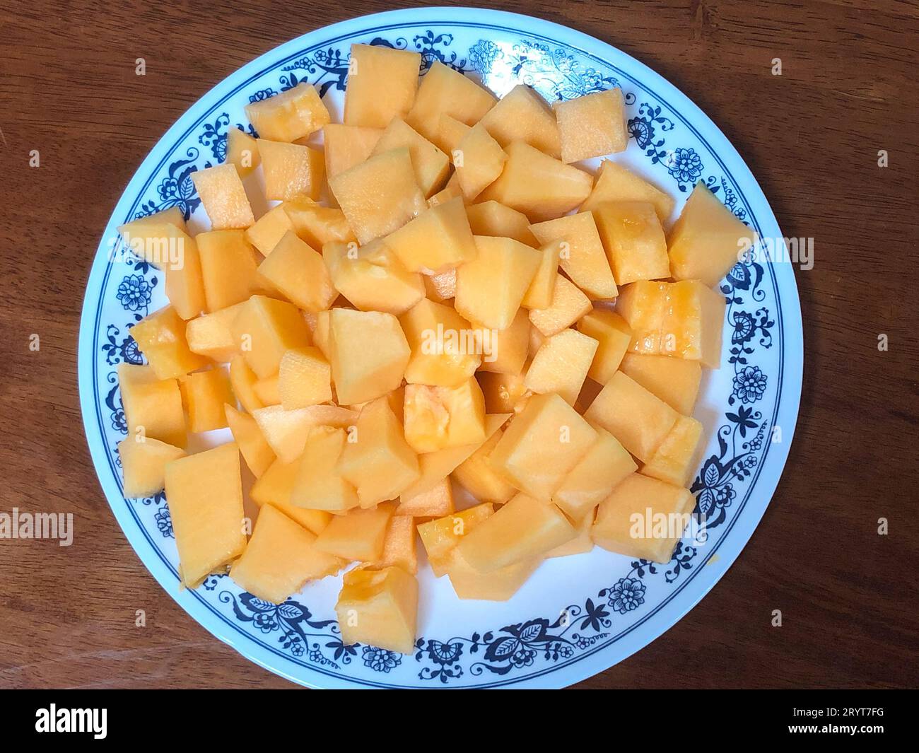 Freshly cut Rockmelon cut into small cubes and served on a plate for