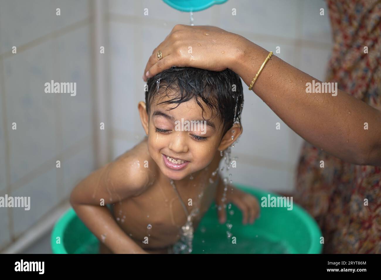 a-2-year-old-indian-baby-boy-enjoying-a-bath-in-a-green-tub-stock-photo-alamy