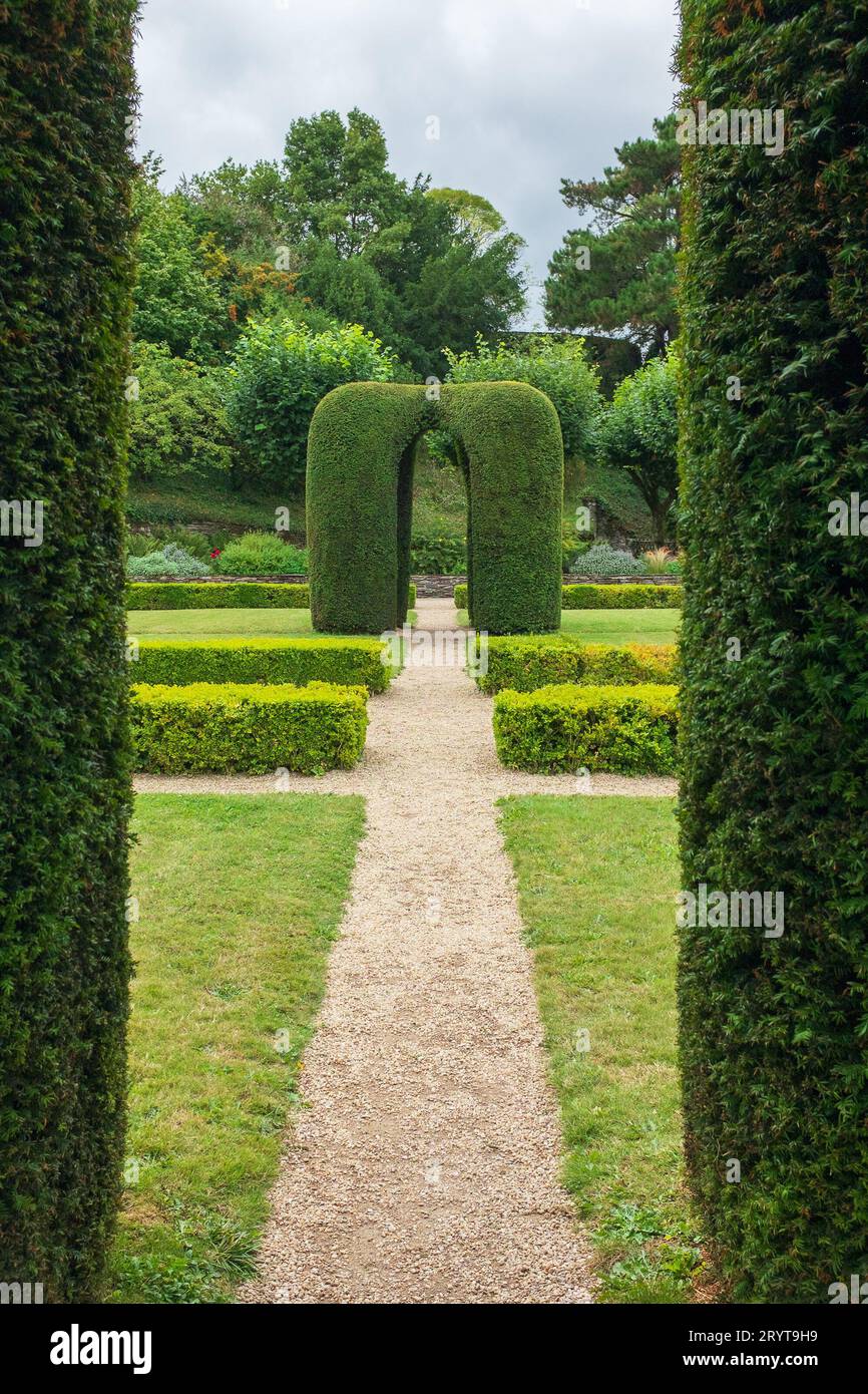Angers, France, 2023. A topiary as seen from under the arch of a yew arbour in the garden between the Governor's and the Royal lodgings (vertical) Stock Photo