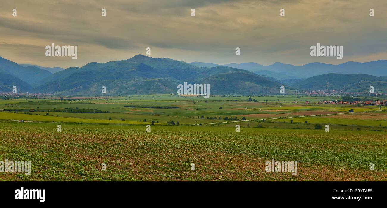 A scenic countryside landscape amongst rolling hills and lush green ...