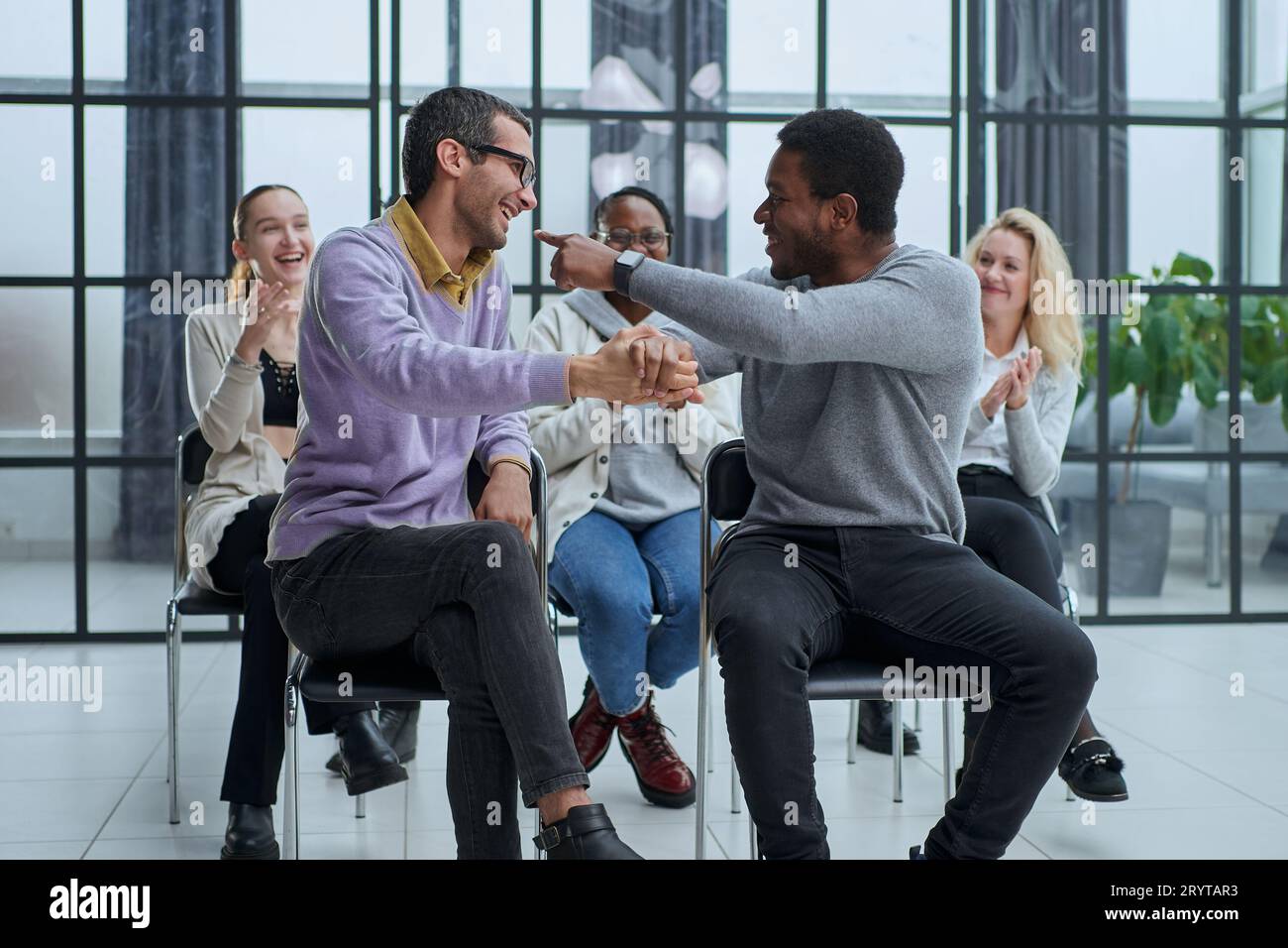 happy friendly diverse professionals, teachers and students giving high five while Stock Photo