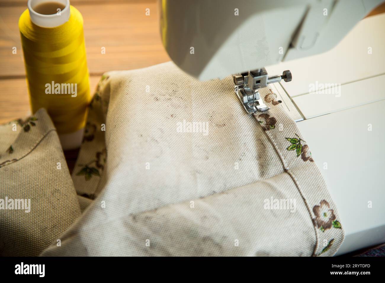 Sewing machine with fabric and threads for sewing, closeup. The