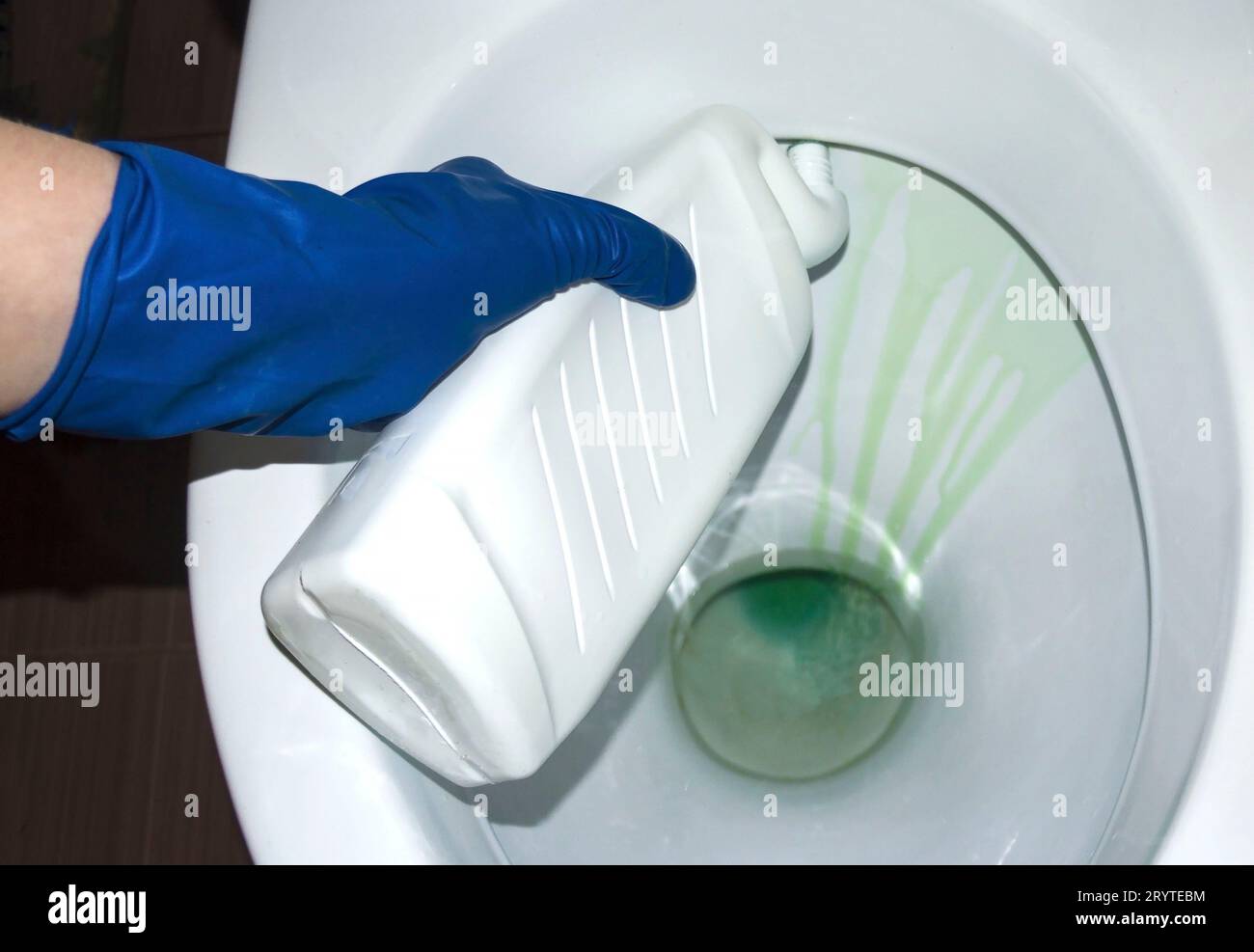 Process toilet disinfectant. Closeup. Hand holds a bottle. Purity in a