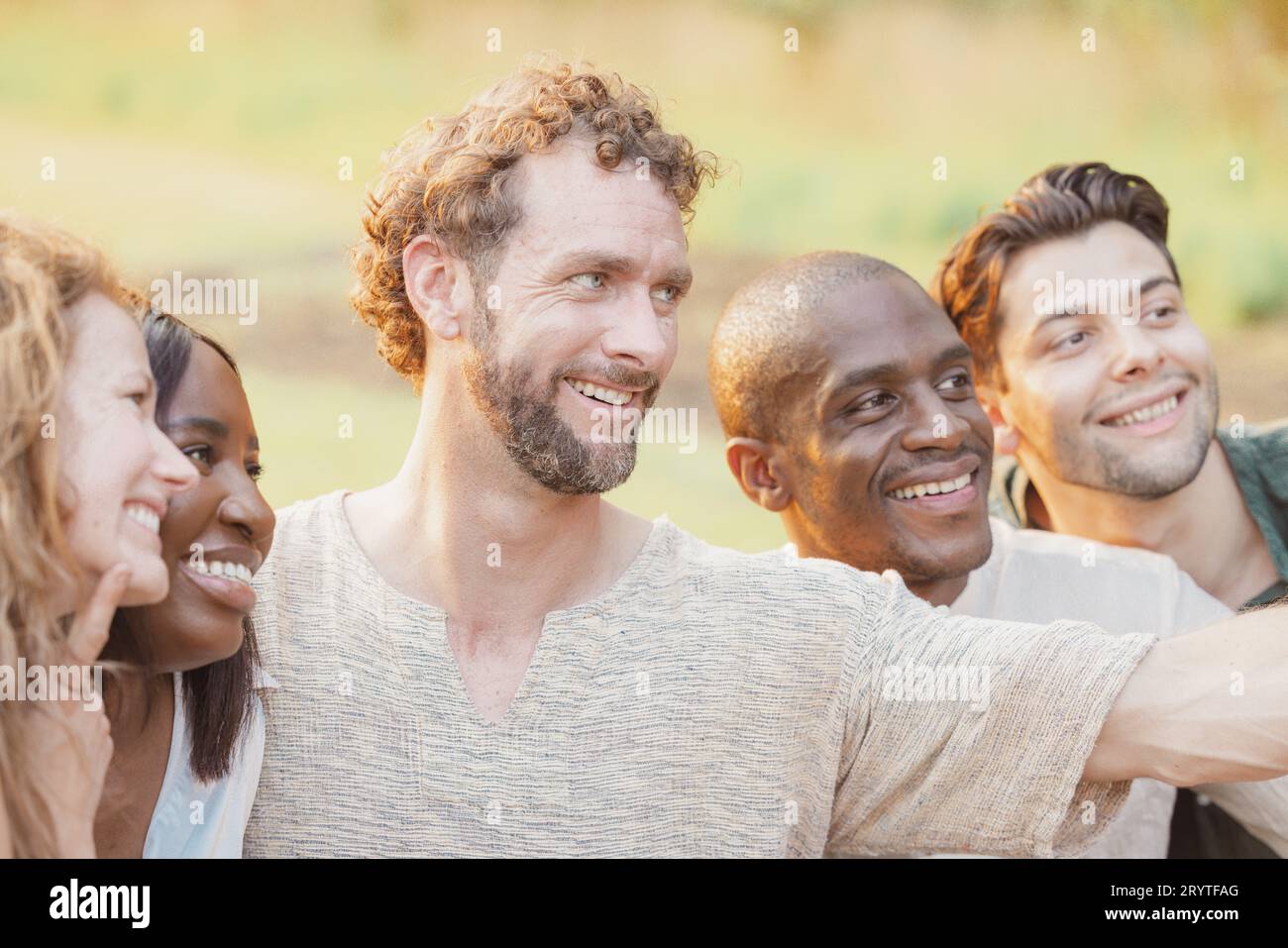 Multiracial group of young happy people smiling and taking selfie photo while walking outside in summertime Stock Photo