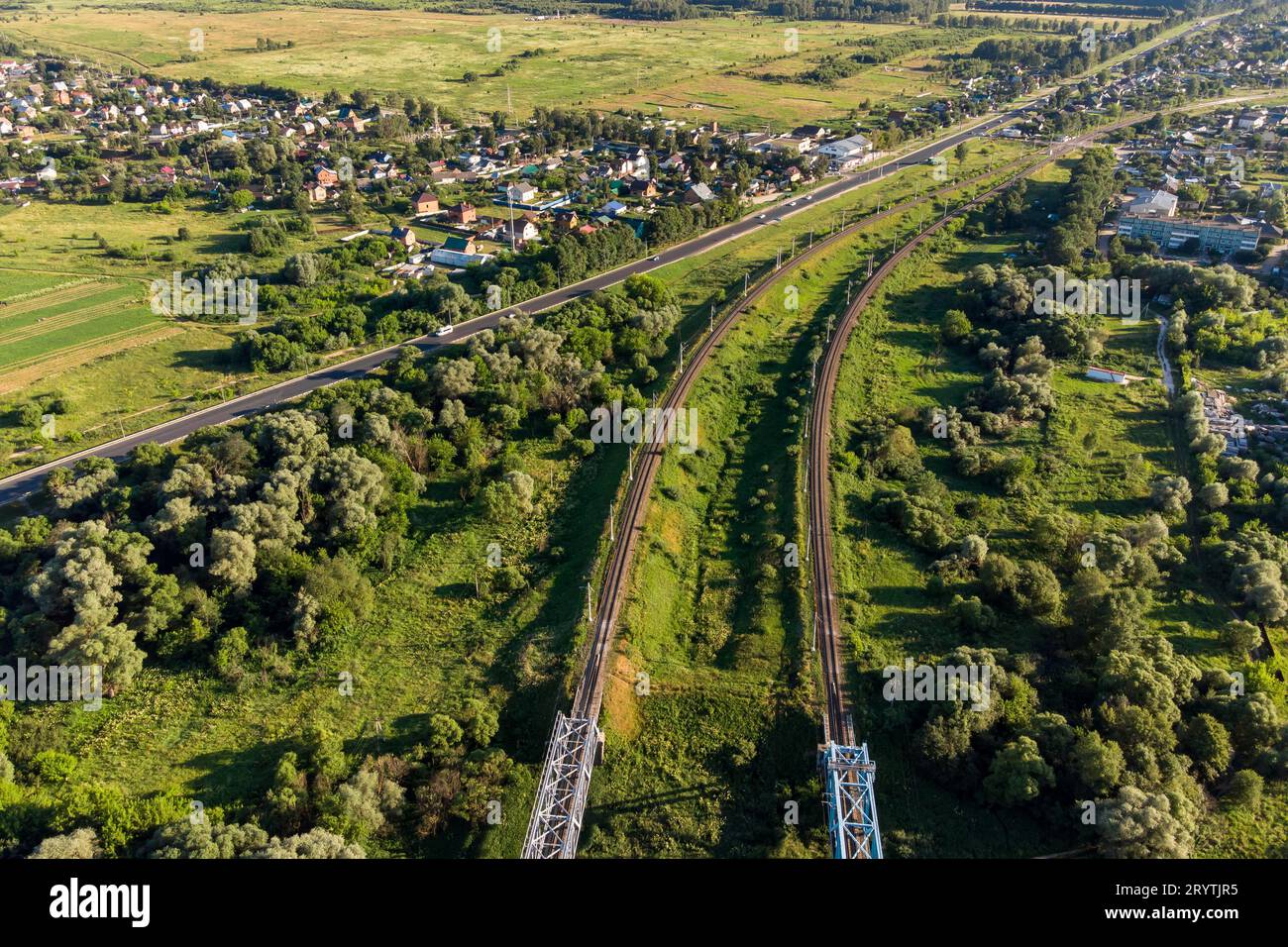Rural landscape from a high altitude. View of the railway tracks and roads passing through the village Stock Photo