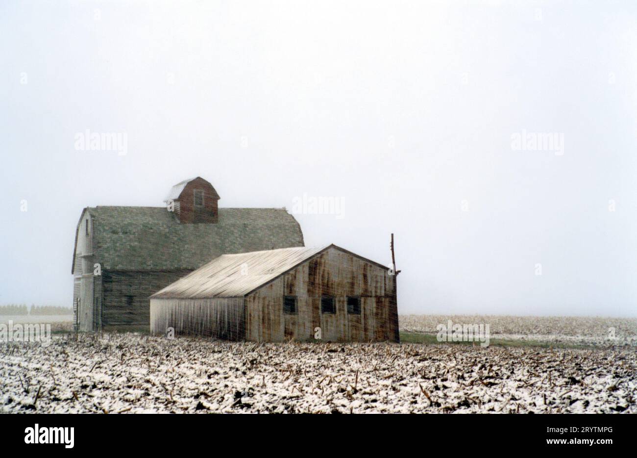 Farm outbuildings in a snow storm Stock Photo