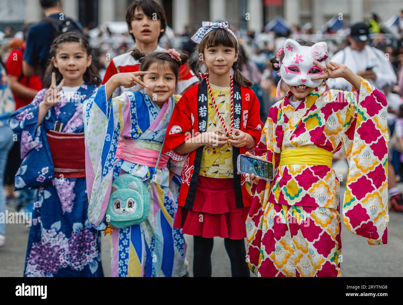 Young children in traditional japanese outfits pose for a photo at Japan Matsuri 2023 in London. Stock Photo
