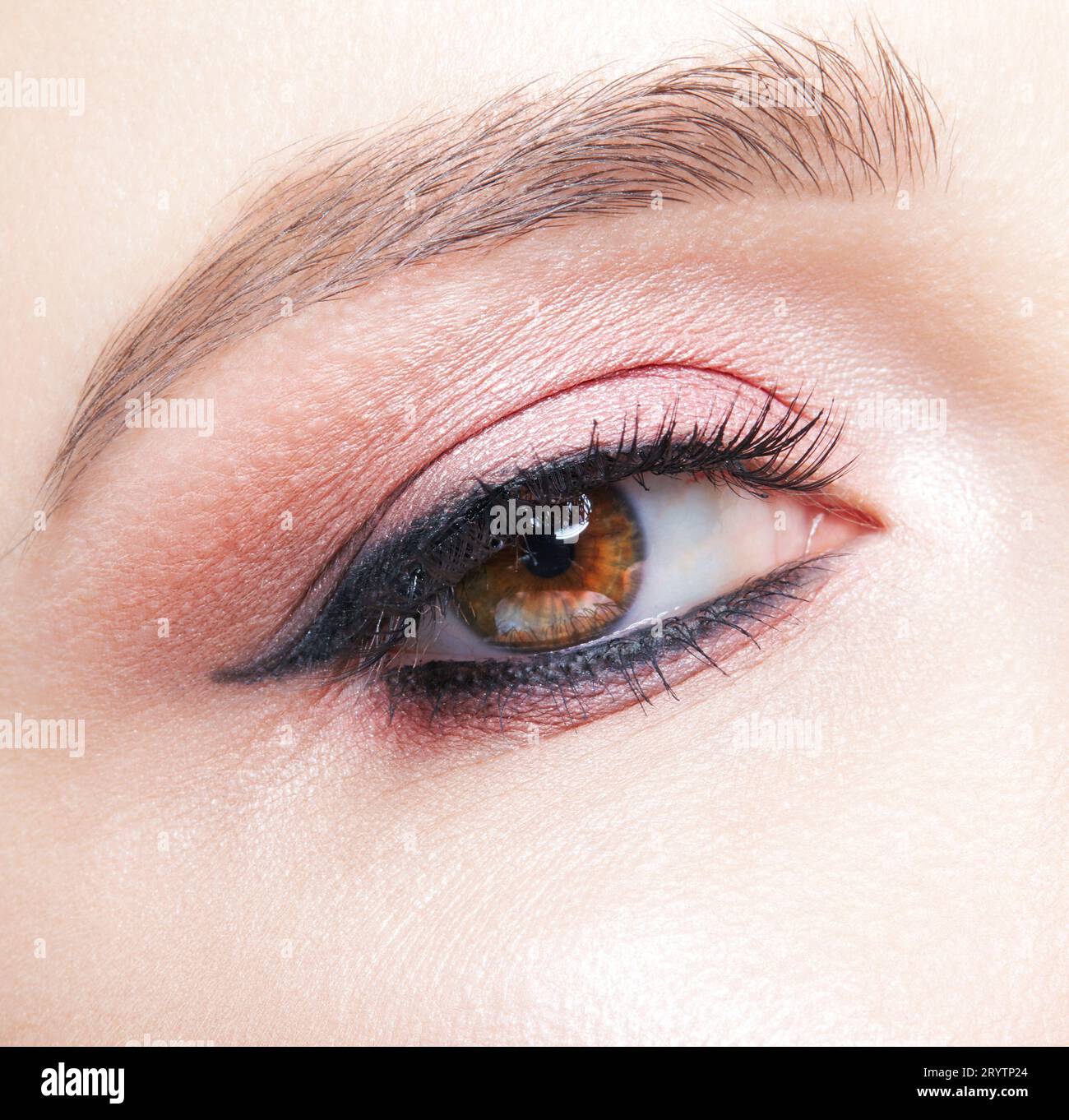 Closeup macro shot of human female eye with pink eyes shadows Stock Photo