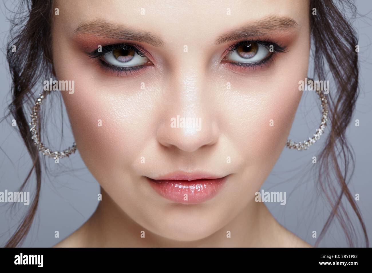 Closeup shot of human woman face. Female with  face and eyes beauty makeup with pink smoky eyes eye shadows Stock Photo