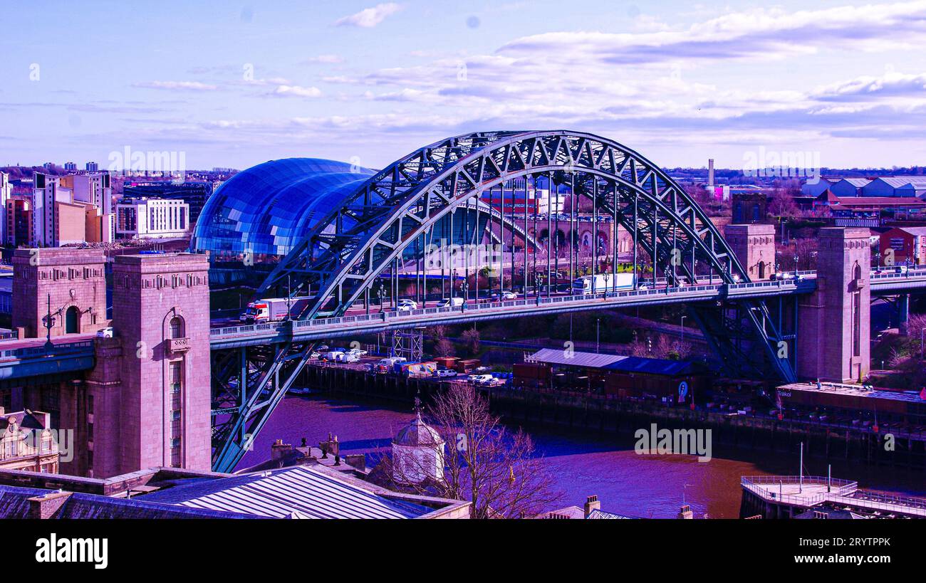 A picturesque stone bridge with arches spans a tranquil river: Tyne Bridge Stock Photo